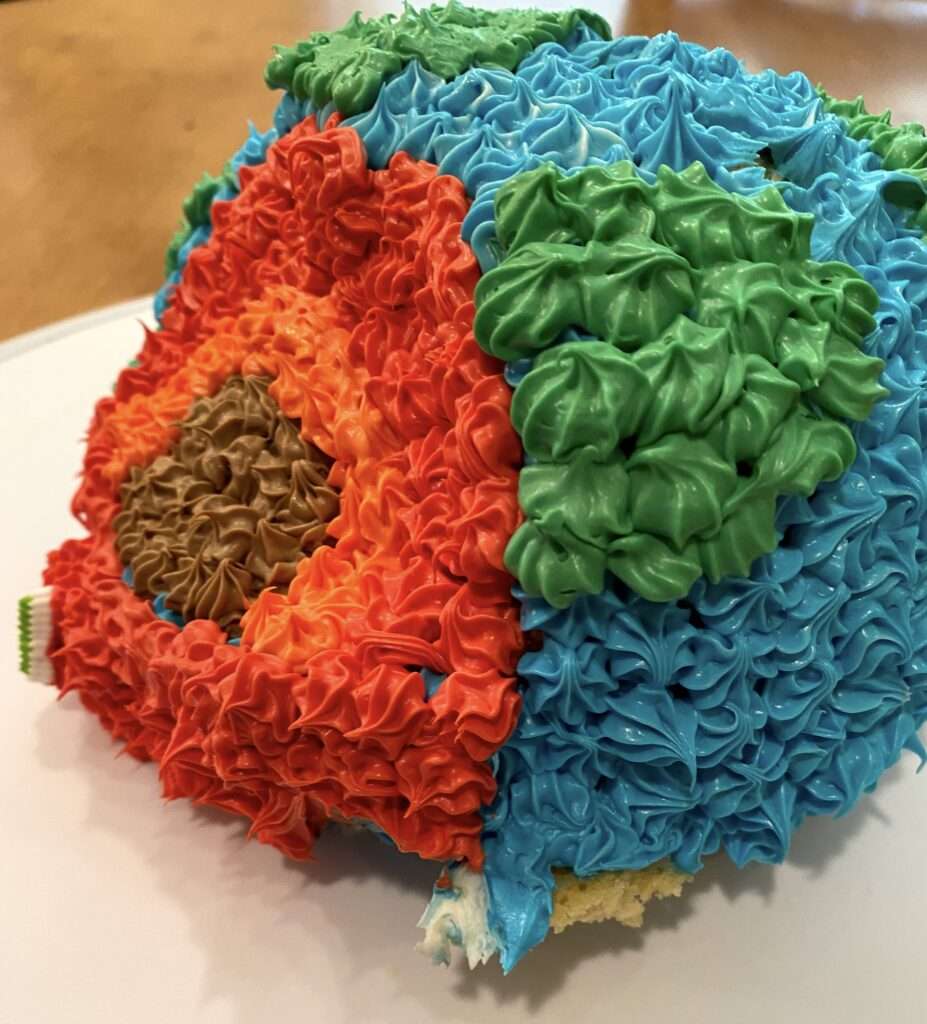 3-D Earth cake with slice cut out of it and magma pouring out
