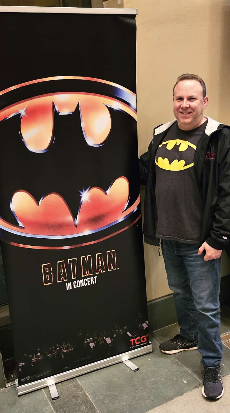 Standing by the Batman in Concert sign